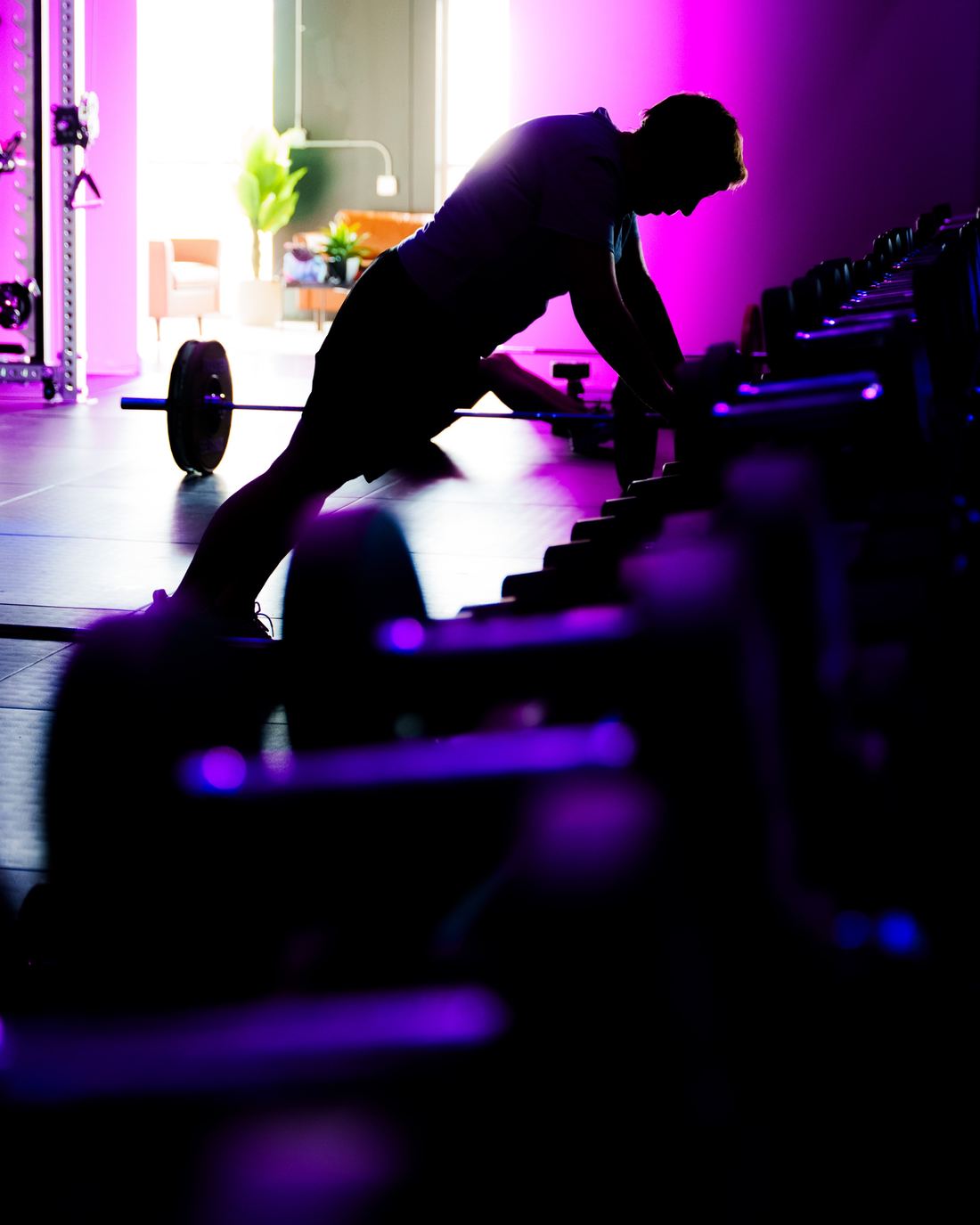 A member holding a plank in silhouette