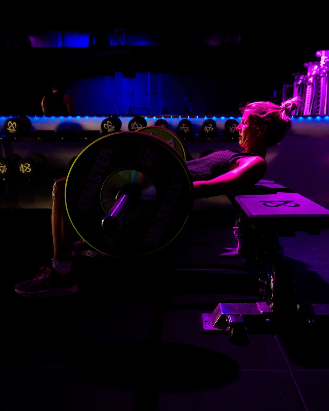 A member doing a barbell hip thrust