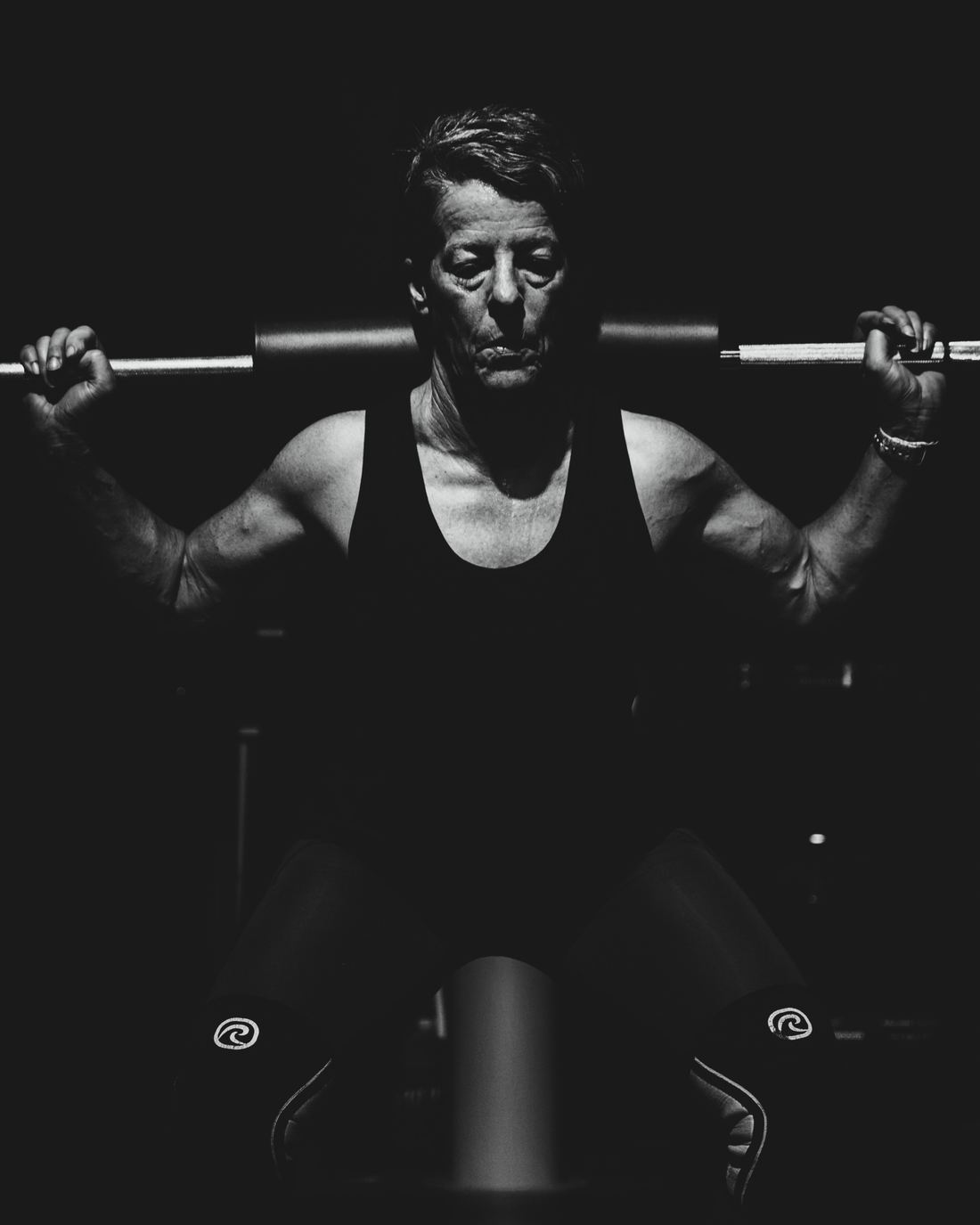 A member squatting a barbell with control